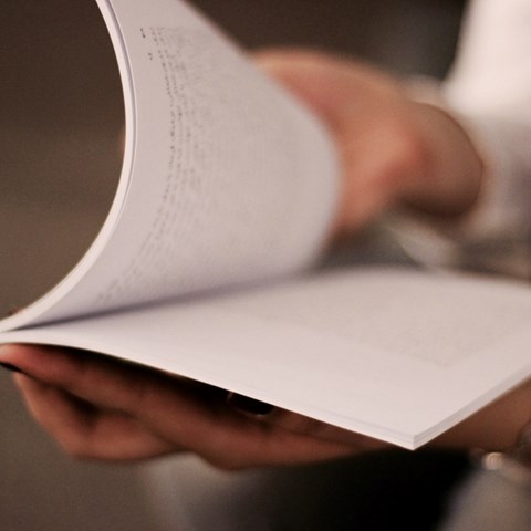 Person holds book
