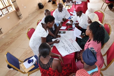 Persons sitting around a table talking