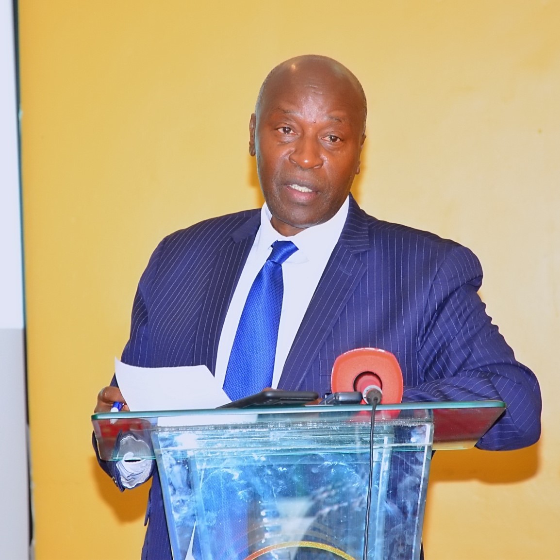 A man speaking behind a podium