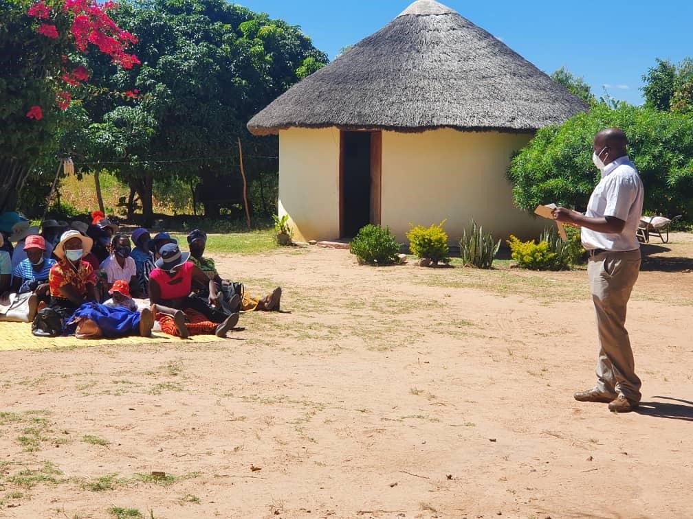 A person holding a lecture outside in Africa. 