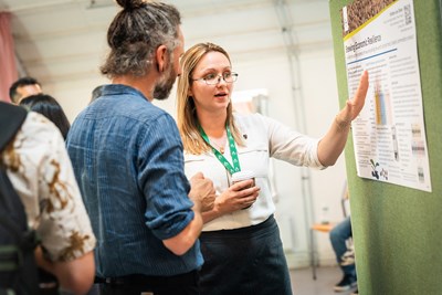 two persons discussing a poster