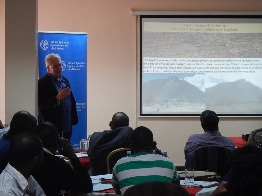 A facilitator is showing a presentation slide to an audience in Nairobi.