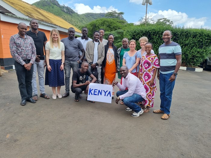 A group photo with a Kenya sign