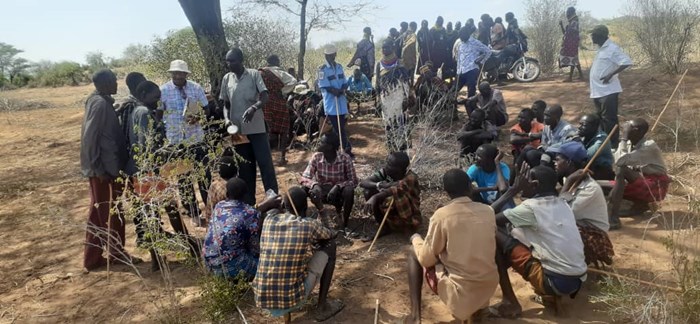 Villagers gathered in the shade in Uganda