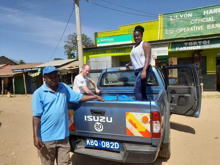 Two persons are packing a pick up car.