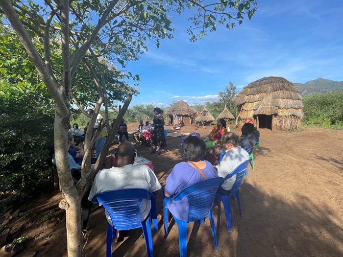 People sitting in a group in the shade