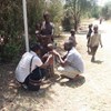 A young child in Kenya is being measured