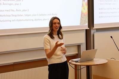 Woman presents in front of white board