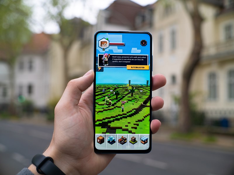 A smartphone with Minecraft on the screen