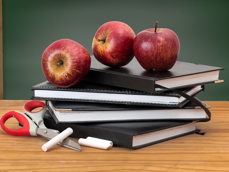 Three apples on a pile of books