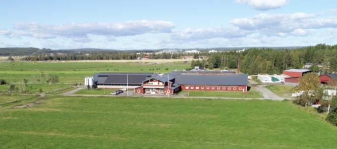 An picture of a barn surrounded by fields fromt he air. Photo. 