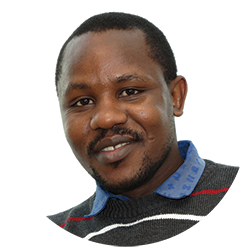 Head image of a man with dark skin and black hair, he is wearing a striped shirt. Photo.