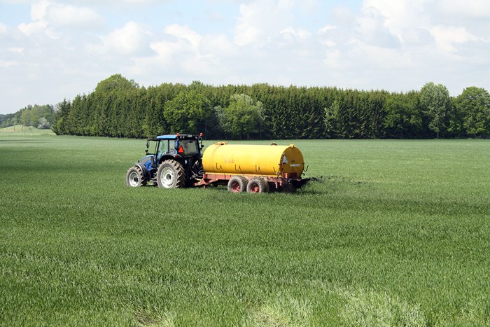 A tractor on a green field, photo.