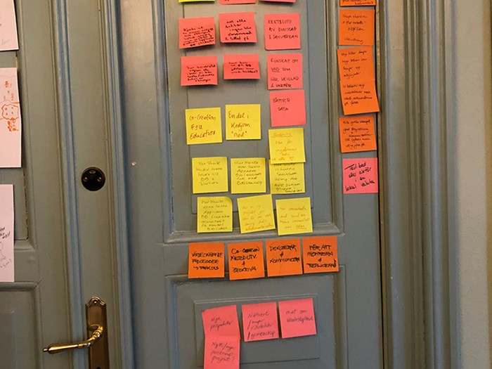 Post-it notes in various colours stuck to a door.