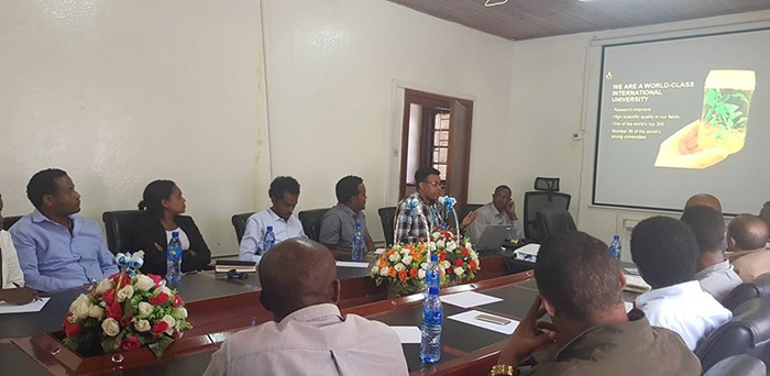 Workshop in Addis Ababa, people sitting around a table. 