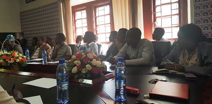 Workshop in Addis Ababa, people sitting around a table. 