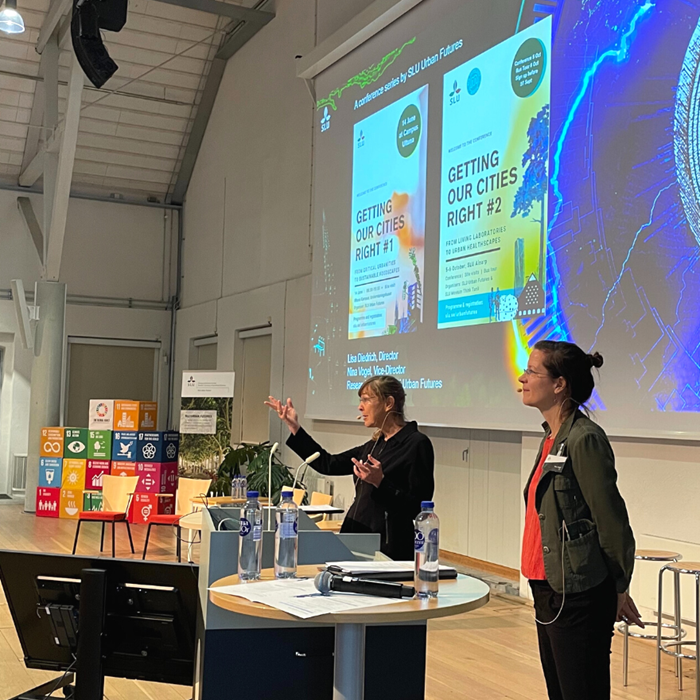 Two women presenting on a stage.