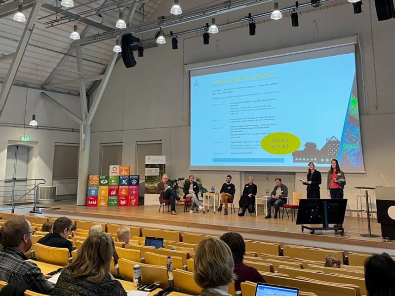 Group of people on conference stage.