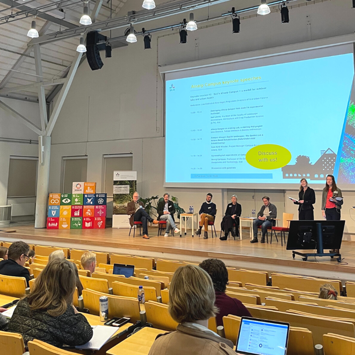 People on stage during a conference.