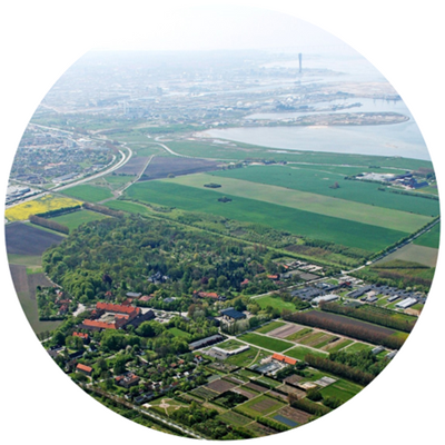 View of a landscape of arable land and a city on the horizon.