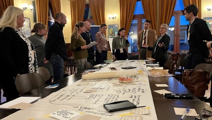 People standing around a big table.
