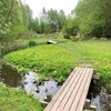 Wooden bridges over a stream in a green landscape.