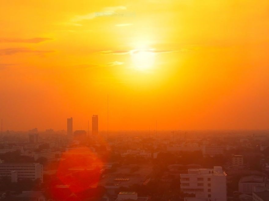 Red sky over a city silhouette.