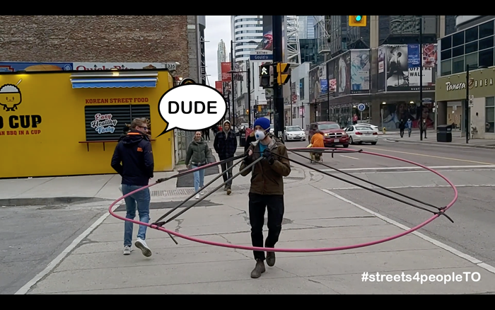 Social Distance Machine, a giant wearable hoop made out of plastic conduit piping and bicycle inner tubs to clearly demonstrate how large 2m really is.