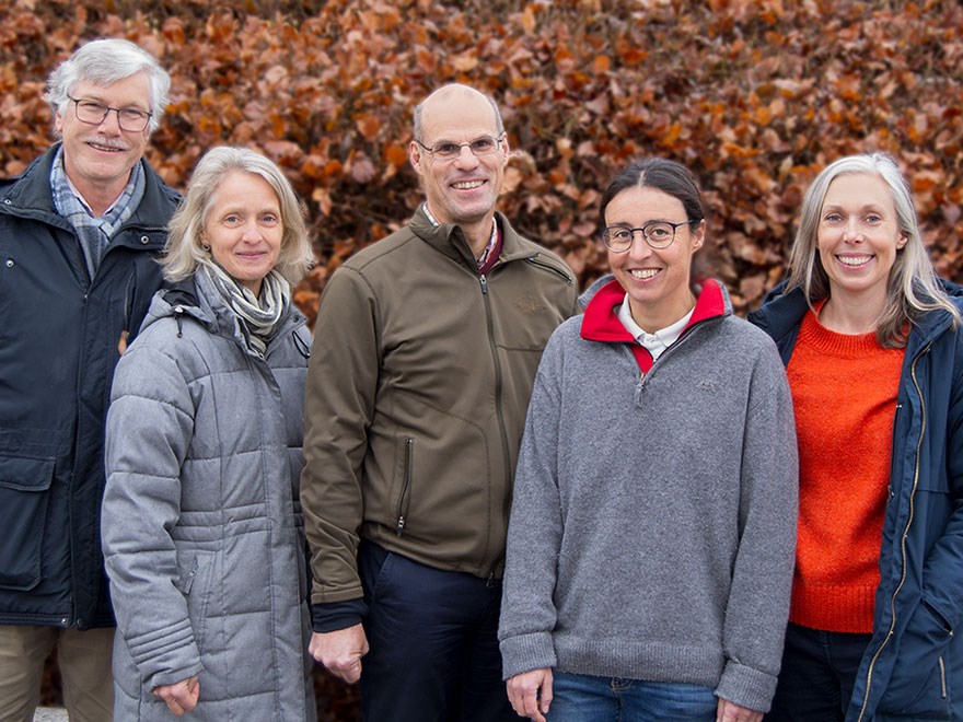 Three woman and two men in a group photo.