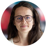 A headshot of a woman with long dark hair and glasses. Photo.