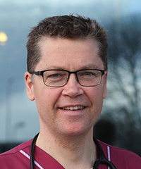 Portrait photo of a man outdoors with stethoscope around his neck, photo.