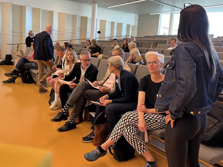 Människor på första bänkraden i en föreläsningssal