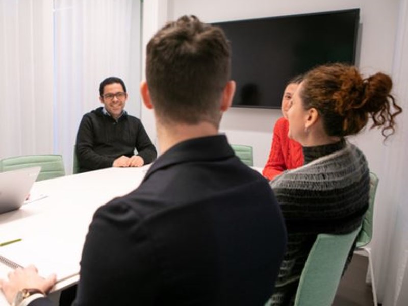 People gathered at a table talking