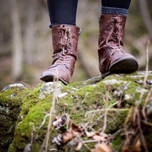 Boots on forest ground.  Photo.