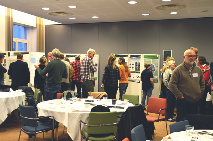 Dialogue around posters. Photo.