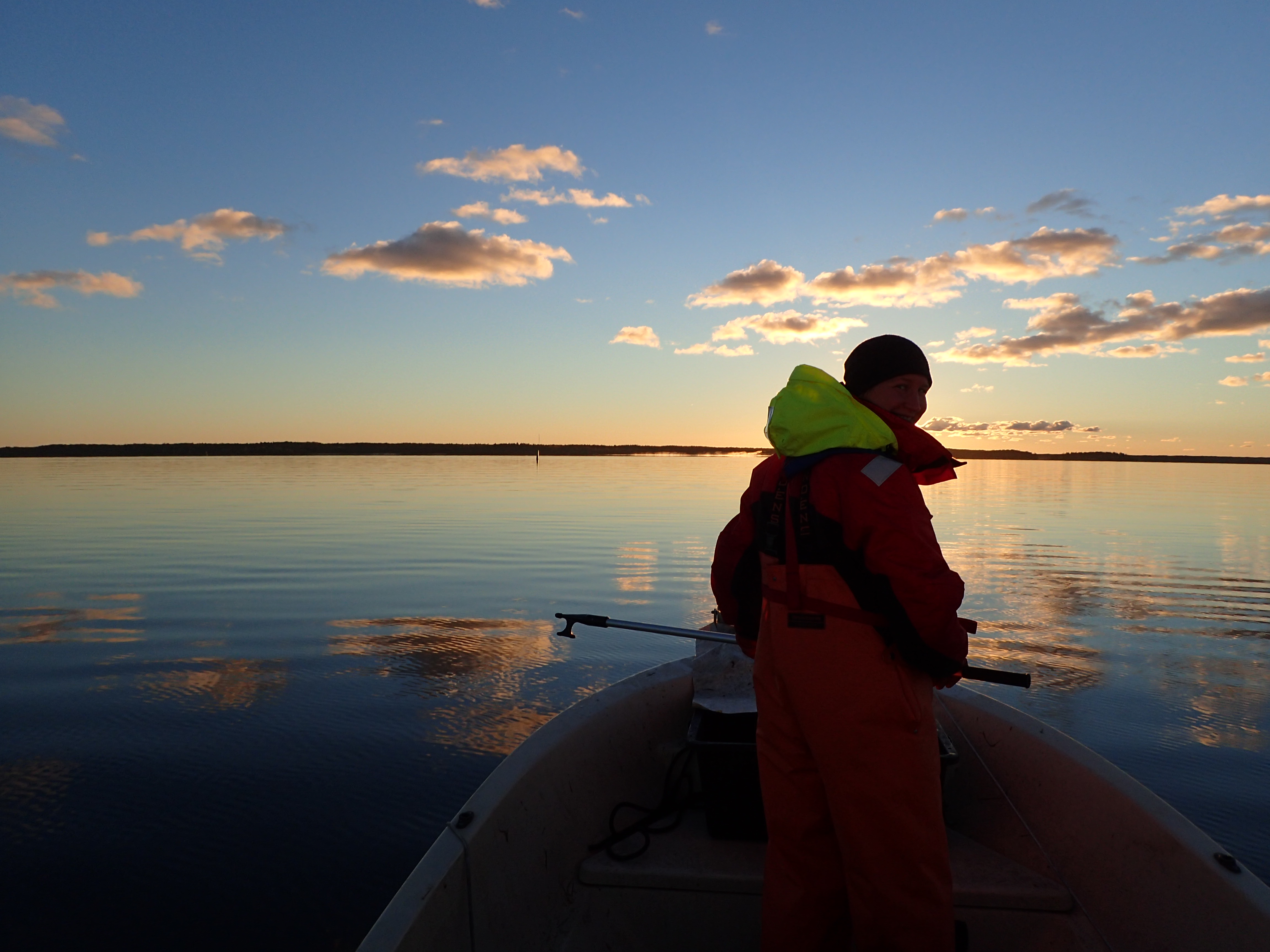 A woman standing in a boat. Photo.