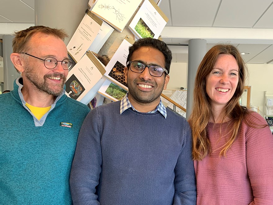 Three smiling researchers