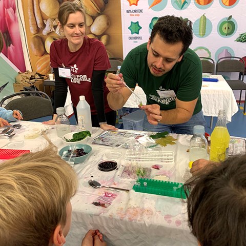 Two researchers talking to children.