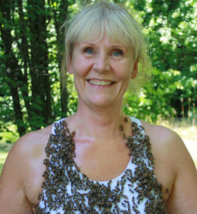 Woman with a sports bra covered in bees.