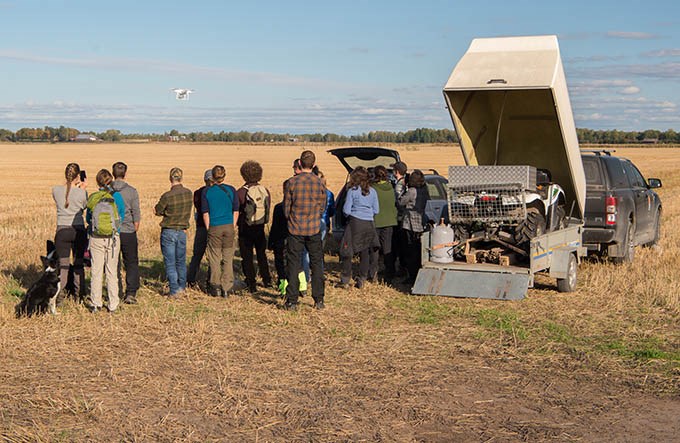 Group of students in the middle of a field.