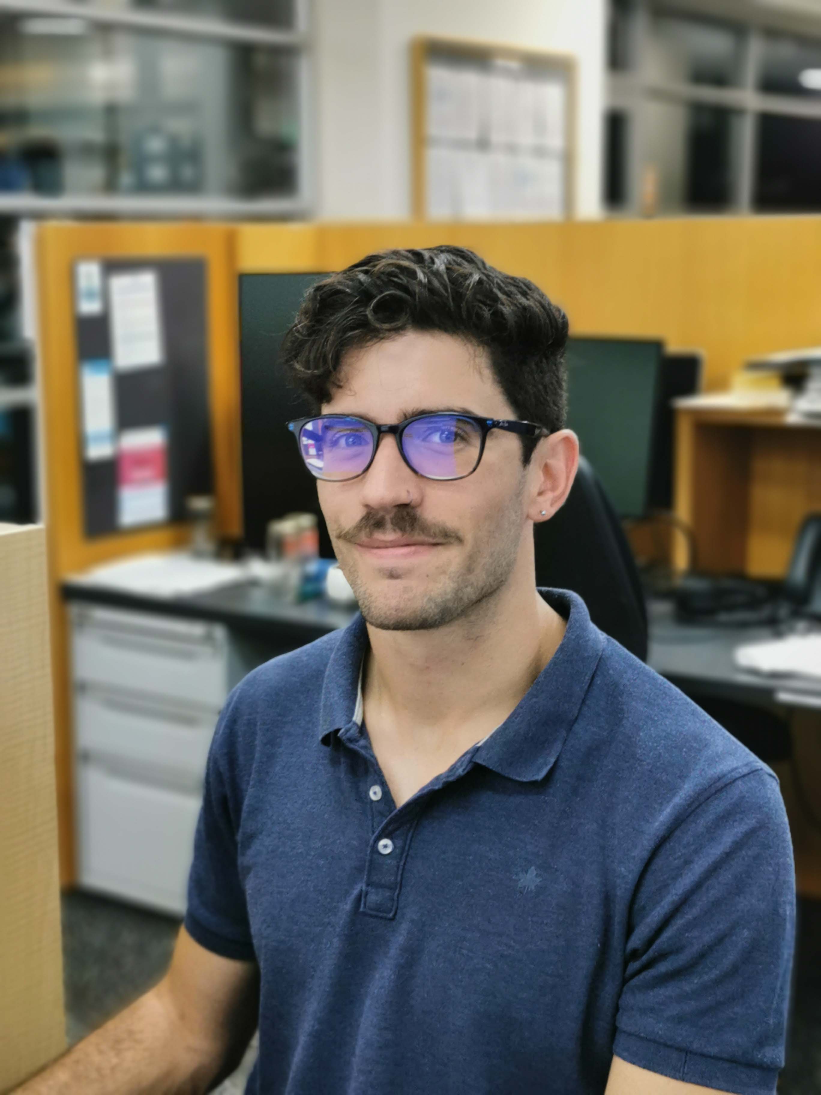 A man sitting in an office environment.