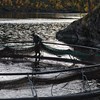Person fixing with a fish farming bag in the water. Photo.