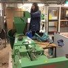 Doctoral student managing extruder machine with silage. Photo.