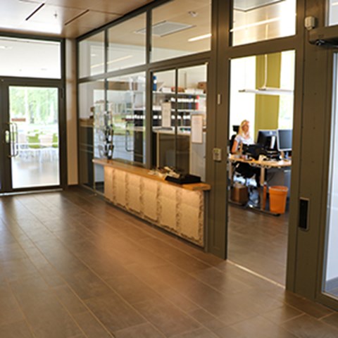 A glass-enclosed indoor room, photo.