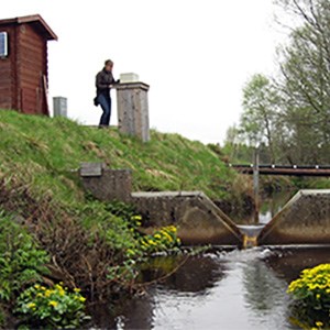 A person at a stream, photo.