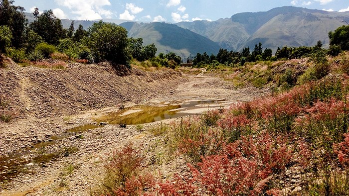 An almost empty riverbed in mountainous landscape. Photo. 