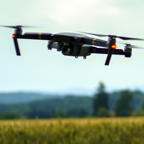 A drone is flying over a field, photo.