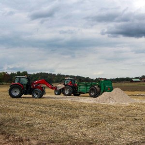 Two tractors on a field. Photo.