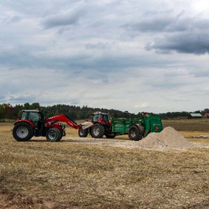 Two tractors on a field. Photo.