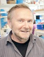 A smiling man in a laboratory, photo.